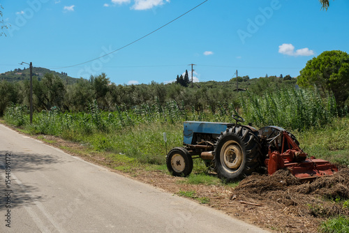 Old tractor on a field in Greece