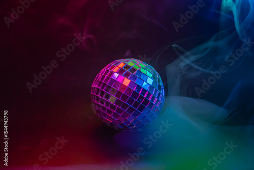 Image of a vibrant disco ball with a colorful, dynamic background Reflects light, evoking themes of partying and celebration related to the 1970s disco era