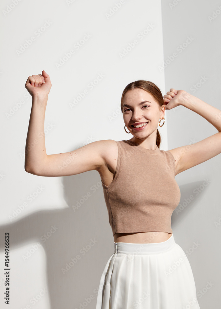 The happy woman smiles and raises her hands up The happy woman smiles and raises her hands up