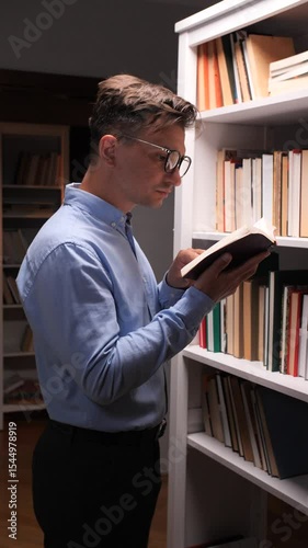 vertical video Researcher reading a book in a library, surrounded by knowledge