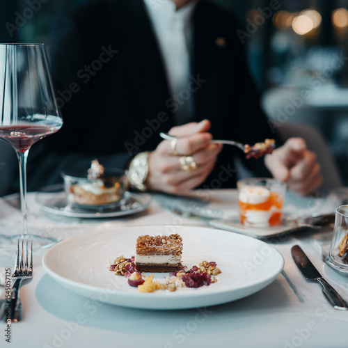 A person enjoying a fancy meal and dessert.