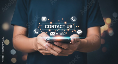 Person holding phone with contact us icons floating above it against a dark background scene