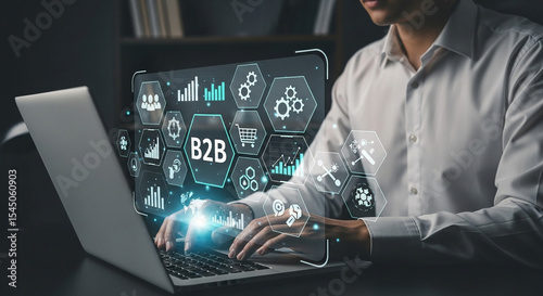 Man typing on laptop with b to b business icons and charts overlayed on the screen showing growth