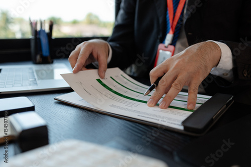 a businessman is reviewing accounting and financial statistics documents in his private office, the statistician prepares various charts and documents for a meeting