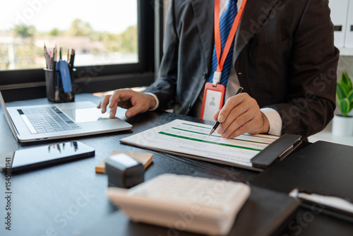 a businessman is reviewing accounting and financial statistics documents in his private office, the statistician prepares various charts and documents for a meeting