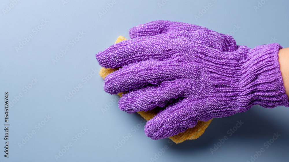 Fototapeta premium Exfoliating glove scrubbing back area gently