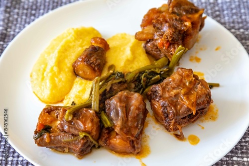 Quadro su tela Delicious Brazilian food, oxtail stew with watercress and polenta, a gourmet dis