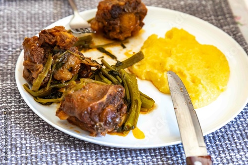 Quadro su tela Delicious Brazilian food, oxtail stew with watercress and polenta, a gourmet dis