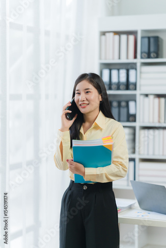 Young Woman Talking on Phone in Office Free Download Young Woman Talking on Phone in Office - GFXLoad