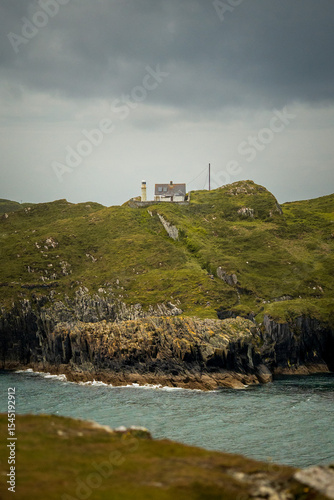 A Scenic Coastal Lighthouse Positioned on a Rugged Cliff Overlooking the Ocean
