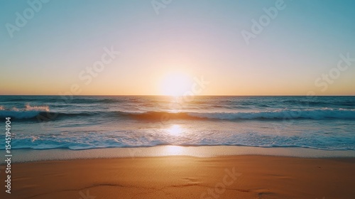 A serene beach sunset scene.  Golden light paints the sky and waves