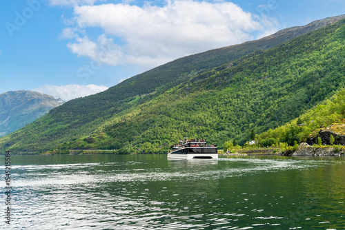 Tourist boat navigating the stunning Norwegian fjord