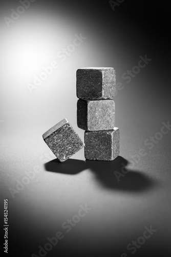 Minimalist abstract still life of 3D shape composed of stone cubes in harsh light with deep shadows