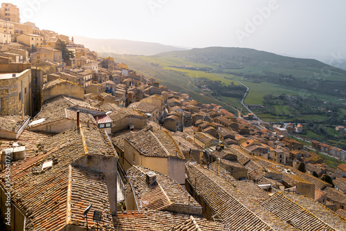 Hilltop town hundreds of similar brown old buildings under tiled roofs at day, Gangi, Sicily, Italy