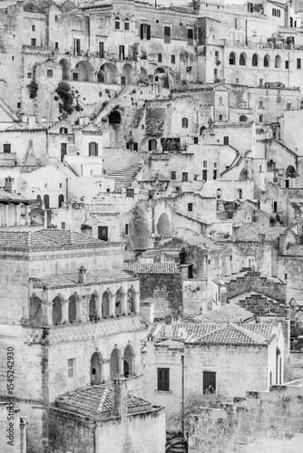 Matera, Italy. Black and white close-up view of the ancient stone houses and architecture in the historic Sassi di Matera, Italy, a UNESCO World Heritage Site in southern Italy. Vertical. 