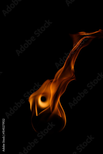 Captivating Flame Against Dark Background with Fluid Movement and Color