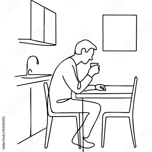 Man sitting alone at kitchen table and holding a cup at night  
