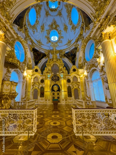 A stunning wide-angle view captures the breathtaking interior of the Grand Church of the Winter Palace, showcasing its resplendent gilded decor and intricate architectural details. The ornate altar
