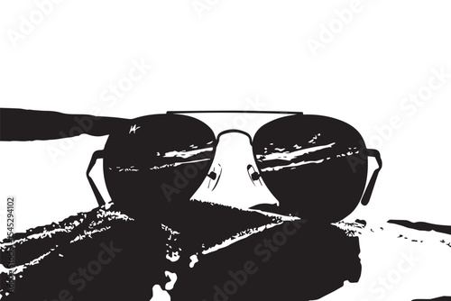 Aviator sunglasses reflecting beach scene resting on sparkling sand in bright daylight setting outdoors