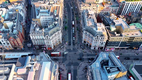 High-angle aerial of Oxford Circus, London’s major shopping and business hub, with busy roads, classic buildings, and red buses. Perfect for travel, retail, and urban lifestyle projects