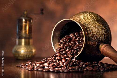 Coffee beans spilling from cezve with traditional copper pattern.
