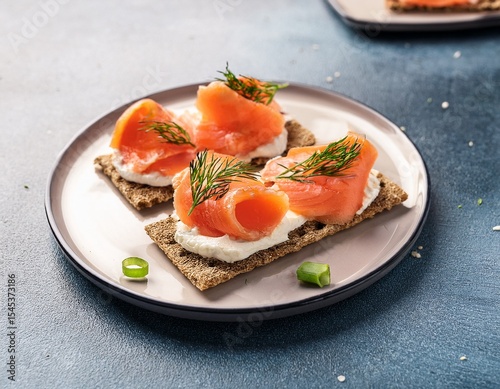 smoked salmon appetizers with cream cheese dill chives and lemon on crispbread