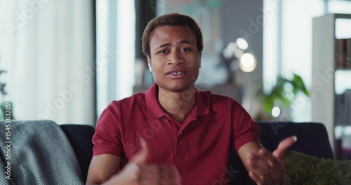 Video portrait of handsome smart african man leading online lecture webinar explaining and teaching looking into camera. Video conference. Businessman.