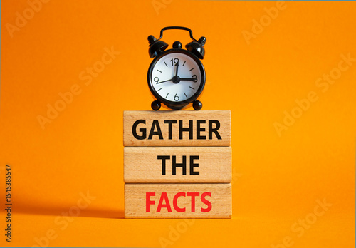 Gather the facts symbol. Wooden blocks with words Gather the facts. Beautiful orange background with alarm clock. Business and Gather the facts concept. Copy space.