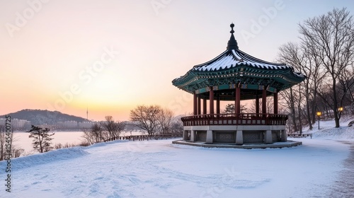 Wallpaper Mural A serene winter scene featuring a traditional pavilion surrounded by snow, against a stunning sunset, Ideal for promoting tranquility, culture, or travel destinations in marketing materials, Torontodigital.ca