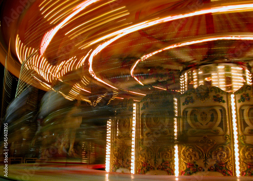 Carousel lights creating swirling patterns of illumination at night.