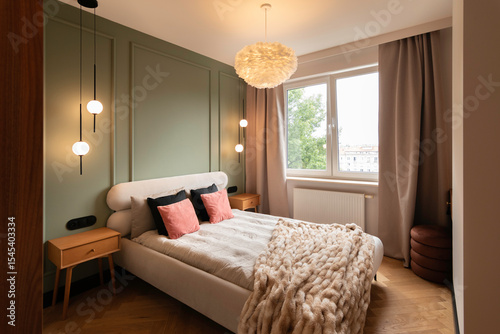 Cozy modern bedroom with sage green accent wall, warm ambient lighting, soft neutral bedding, and elegant minimalist decor in a stylish contemporary apartment interior.