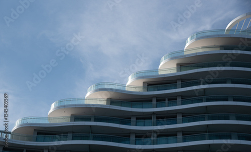 Modern building architecture apartments showing rounded balconies against blue sky