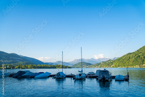 View of boats moored on Lake Lugano, village of Caslano. Switzerland