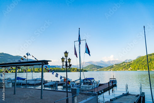 View of boats moored on Lake Lugano, village of Caslano. Switzerland