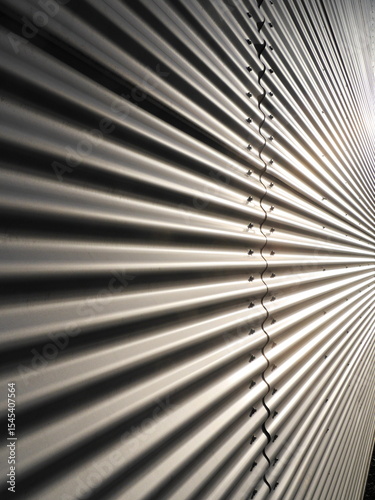 A metal wall with a series of ridges and grooves