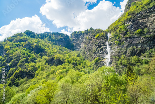 Beautiful small natural waterfall in the spring mountains of Switzerland