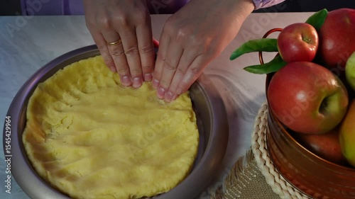 Preparing homemade pie crust with fresh apples in a rustic kitchen setting