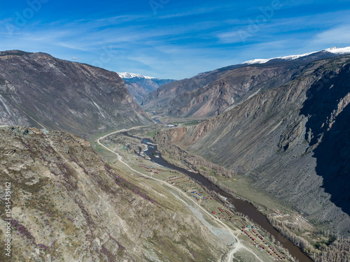 Summer landscape in the Chulyshman mountain valley. Winding mountain river, green alpine meadows and beautiful mountains.