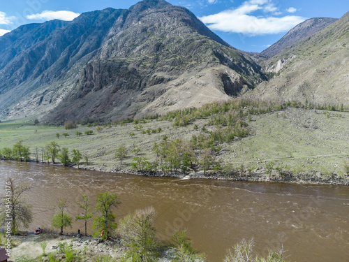Summer landscape in the Chulyshman mountain valley. Winding mountain river, green alpine meadows and beautiful mountains.