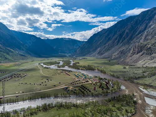 Summer landscape in the Chulyshman mountain valley. Winding mountain river, green alpine meadows and beautiful mountains.