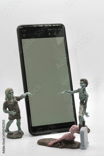 miniature figurines of a group of zombies around a smartphone