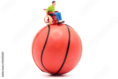 miniature figurine of a man in a wheelchair on top of a basketball