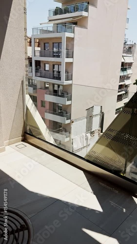 Hand Opening Balcony Door to Outside View