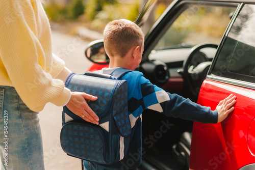 Cuadro en lienzo Back to School Morning Drop Off – Child with Backpack and Parent Getting into Ca