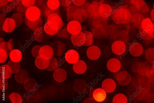 Red bokeh background with soft glowing lights for creative designs and art projects