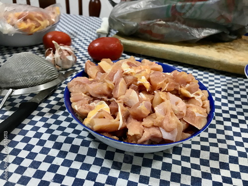 Food Prep on Checkered Tablecloth with Chicken and Vegetables