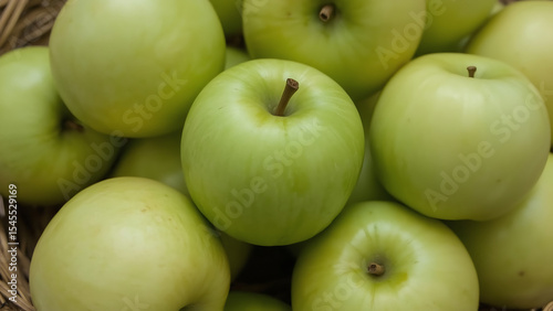 Close-up of a wicker basket overflowing with ripe green apples. Perfect for food and agriculture-themed designs and concepts. Vibrant and fresh.