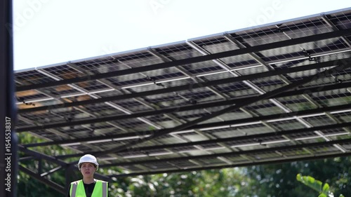 Female engineer inspects solar panel roof with tablet device. Sustainable energy technology, professional monitoring, and smart infrastructure in a modern eco-friendly environment.