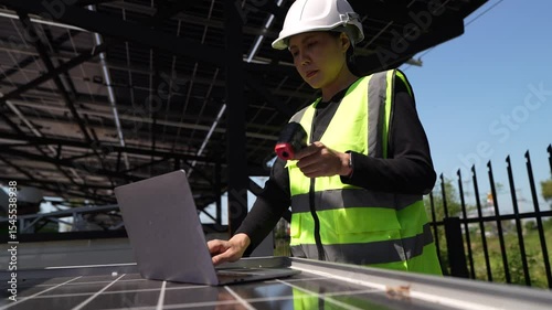 Close-up of engineer's hand testing a solar panel with measurement device, solar energy maintenance and green technology.