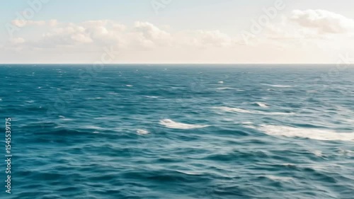 Wallpaper Mural Tranquil ocean scene featuring a vast expanse of deep blue water under a light blue sky dotted with fluffy clouds. Perfect for relaxation themes and travel visuals. Torontodigital.ca